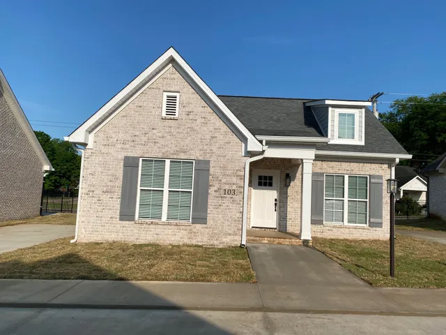 a front view of a house with garage