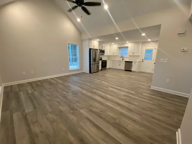 a view of a kitchen with a sink and a refrigerator