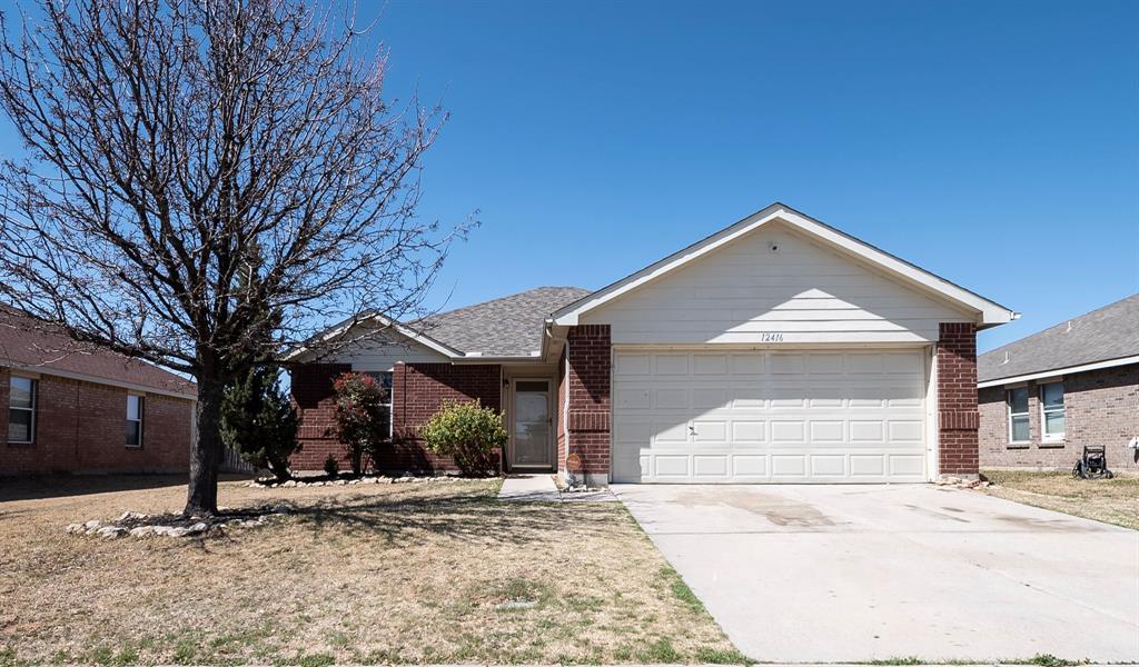 12416 Steel Wood Lane Rhome, TX 76078 - Photo 1 of 1 a front view of a house with a yard and garage