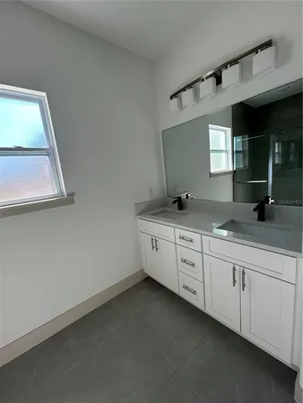 a bathroom with a glass door shower