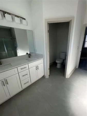 a bathroom with a double vanity sink and mirror