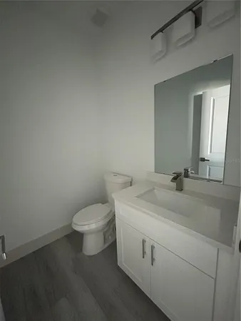 a room with wooden floor and white wall