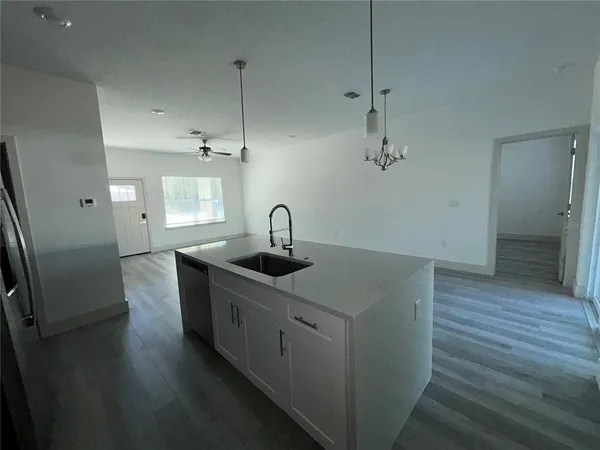 a kitchen with sink and mirror