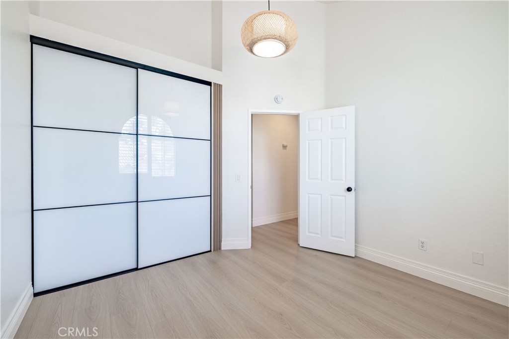 8 Massier Lane Lake Forest, CA 92610 - Photo 21 of 34 an empty room with wooden floor and mirror
