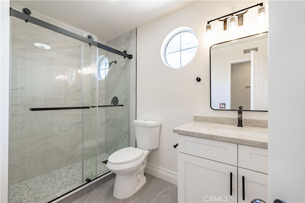 8 Massier Lane Lake Forest, CA 92610 - Photo 24 of 34 a bathroom with a granite countertop sink mirror toilet and shower