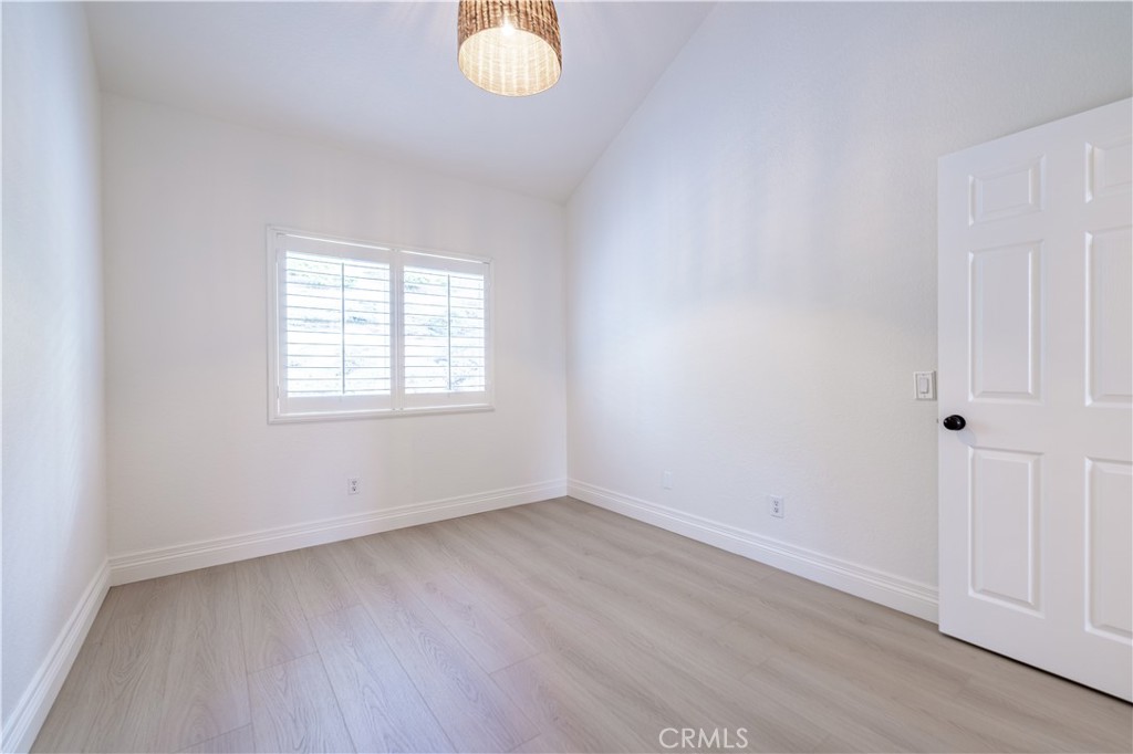 8 Massier Lane Lake Forest, CA 92610 - Photo 28 of 34 an empty room with wooden floor and windows