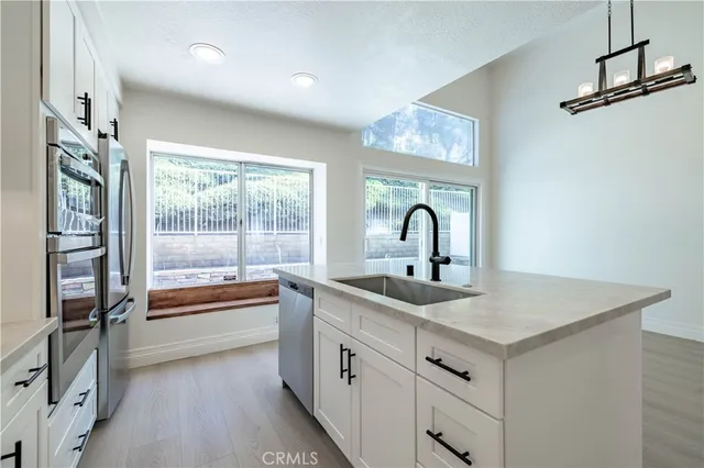 a kitchen with a sink and large window