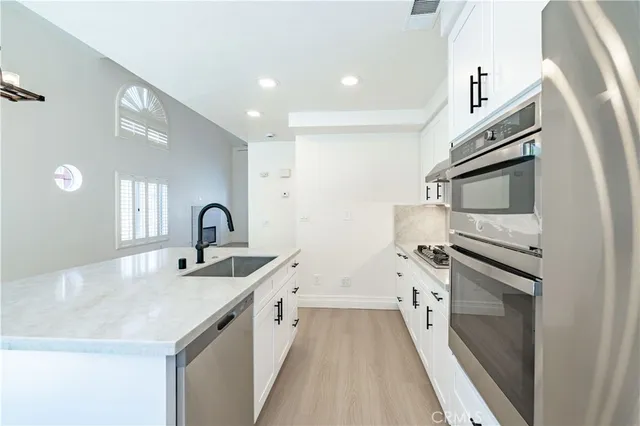 a kitchen with a sink stove and refrigerator