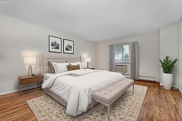 a spacious bedroom with a bed and a window