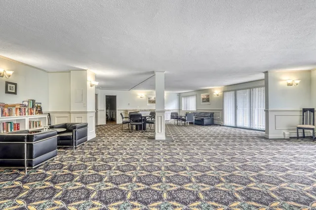a large kitchen with a table and chairs