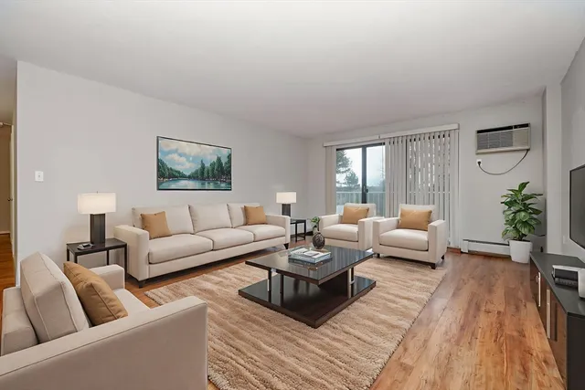 a living room with furniture or couch and a wooden floor