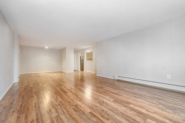 a view of an empty room and wooden floor