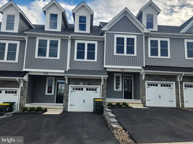 a front view of a house with parking