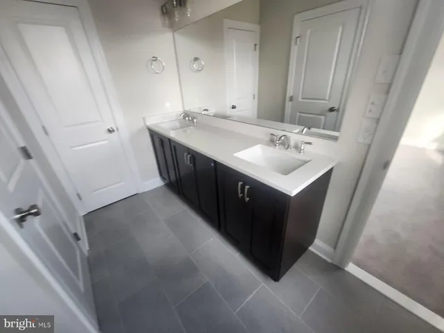 a bathroom with a sink vanity and mirror