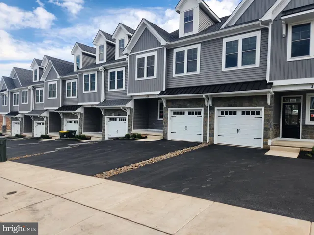 a view of a street that has couple of cars parked in front of it