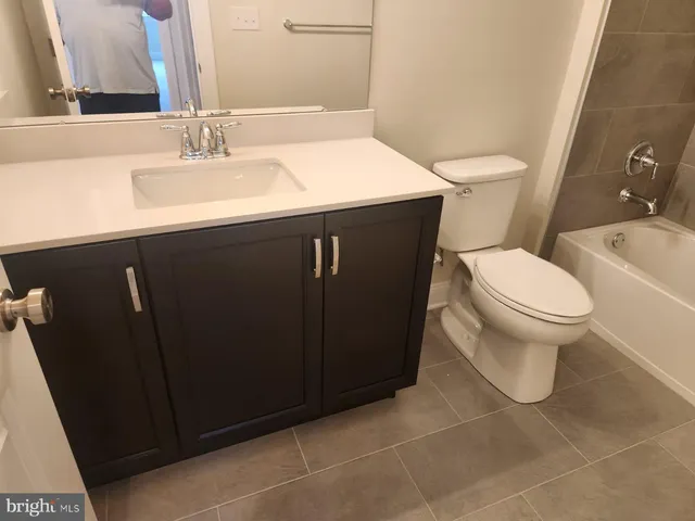 a bathroom with a sink toilet and vanity
