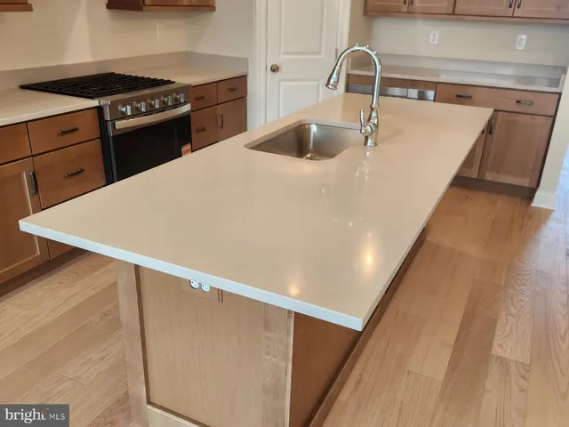 a kitchen with a sink and a stove top oven