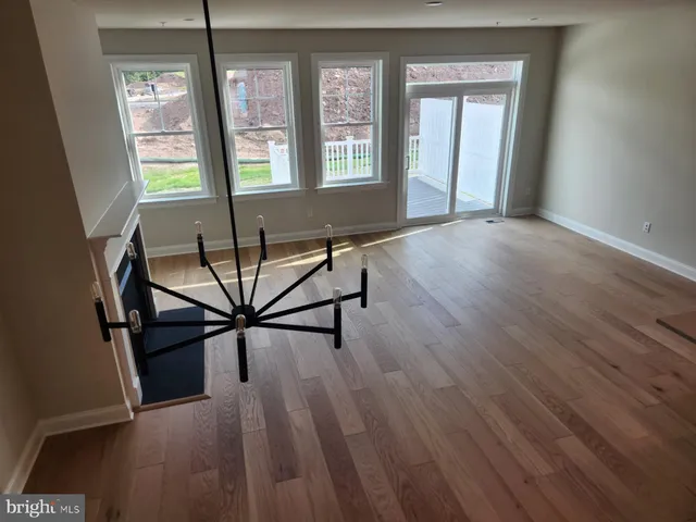 a living room with hardwood floor and a window