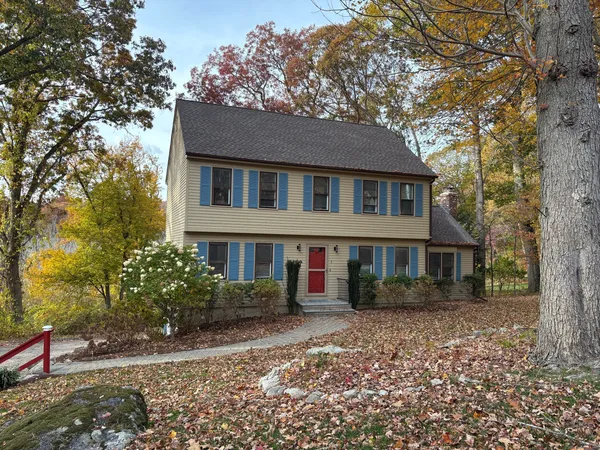 a front view of a house with a garden