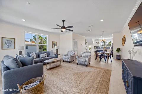 a kitchen with stainless steel appliances a refrigerator and a view of living room