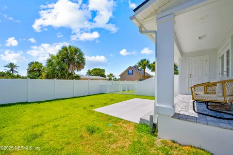 a view of a house with a yard and a patio