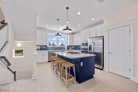 a kitchen with cabinets and stainless steel appliances