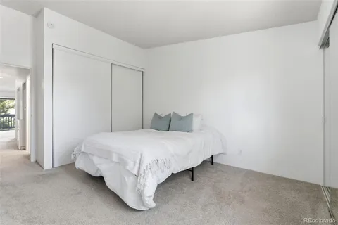 a bed room with a bed and a white wall