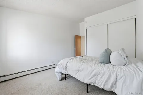 a bedroom with a bed and a mirror
