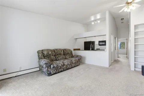 a living room with furniture and flat screen tv