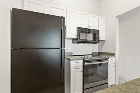 a kitchen with a stove microwave and refrigerator
