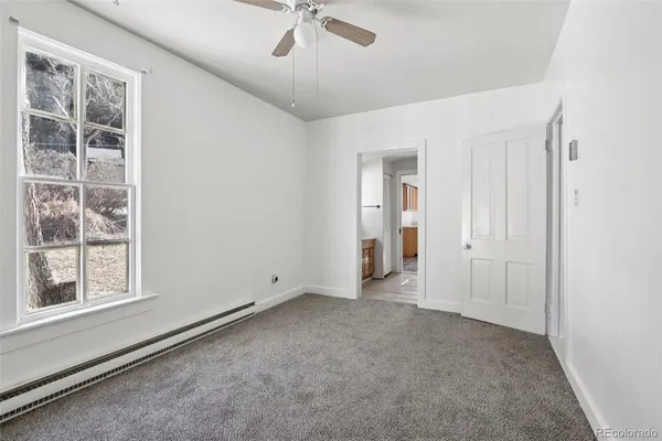 a view of an empty room with a window