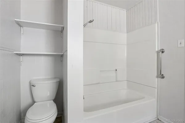 a bathroom with a toilet and a shower