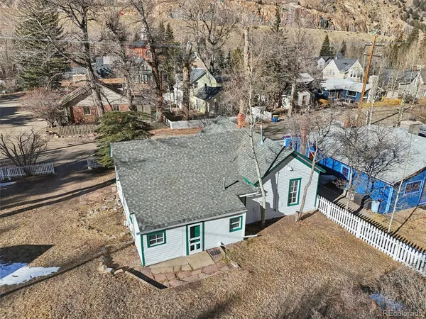 an aerial view of residential houses with yard