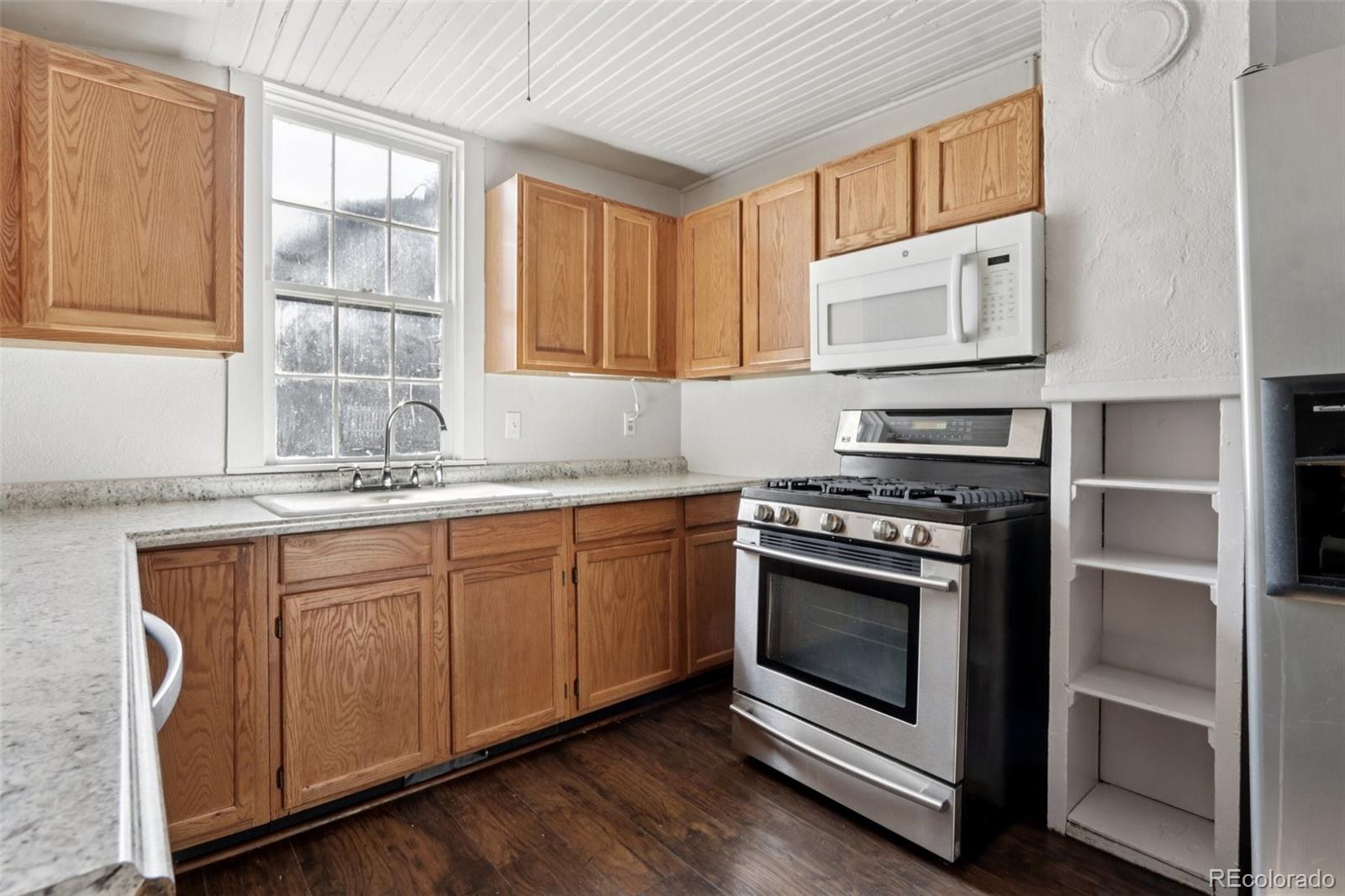 800 Main Street Georgetown, CO 80444 - Photo 9 of 21 a kitchen with granite countertop stainless steel appliances a stove sink and cabinets