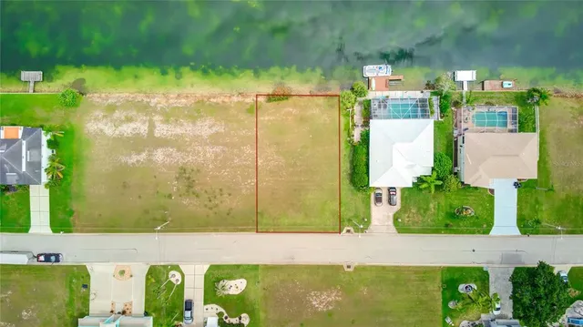 a view of a swimming pool with an outdoor seating and a yard