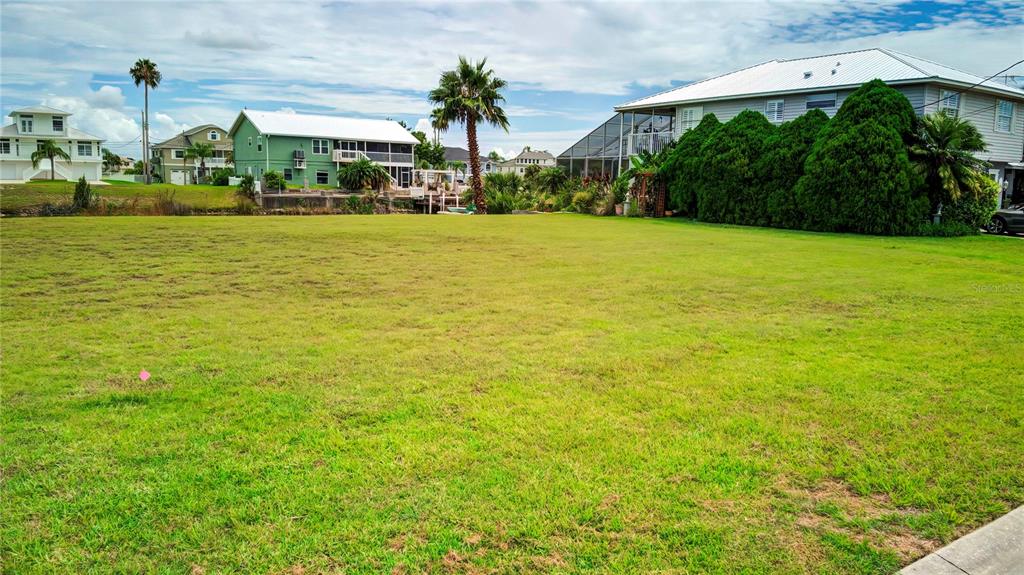 3487 Croaker Drive Hernando Beach, FL 34607 - Photo 13 of 23 a view of a swimming pool with an outdoor seating and a yard