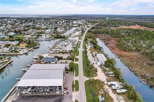 an aerial view of a house with a garden and lake view
