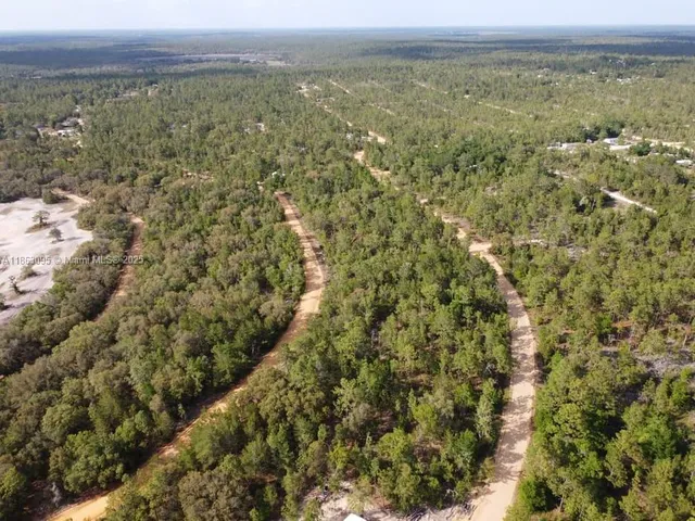 a view of a green field with an outdoor space