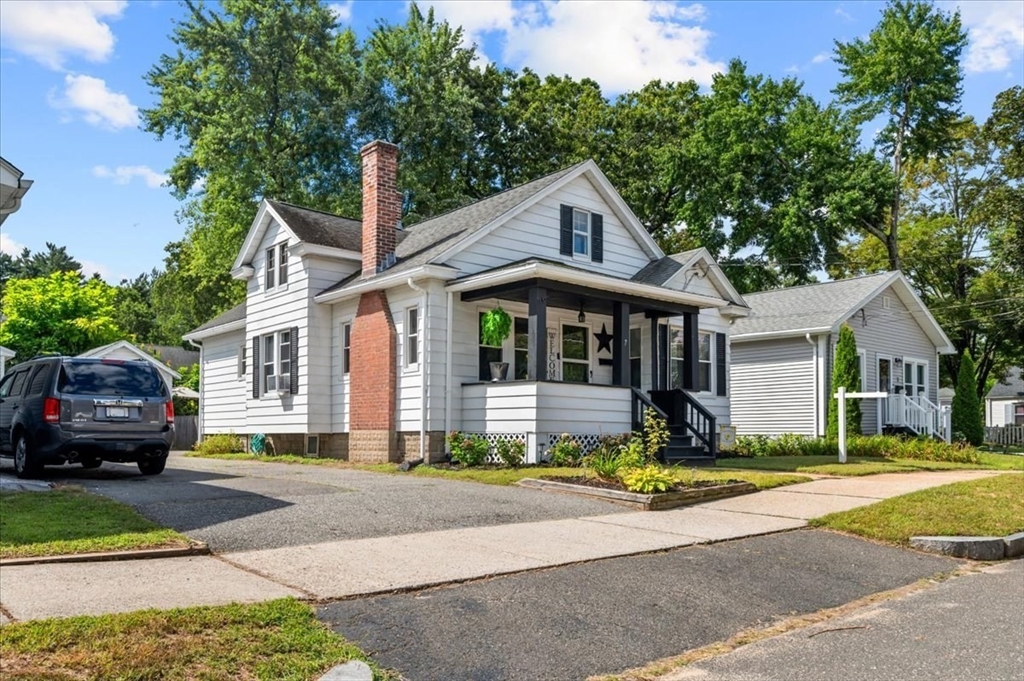 a front view of a house with a garden
