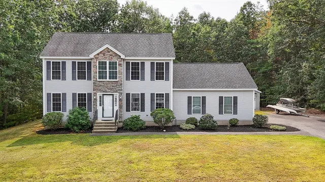 a aerial view of a house with swimming pool next to a yard
