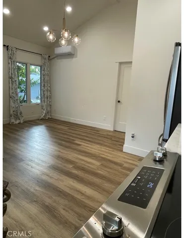 a kitchen with granite countertop white cabinets and stainless steel appliances