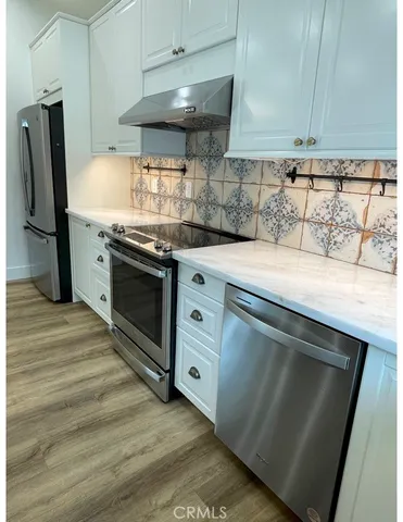 a view of a hallway with washer and dryer