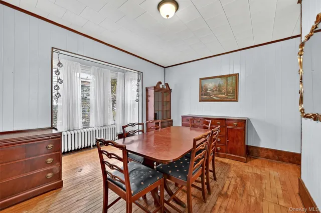 a dining room with furniture and wooden floor