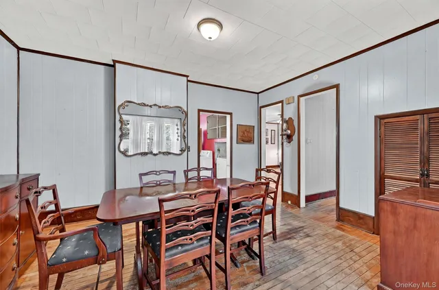 a dining room with furniture and wooden floor