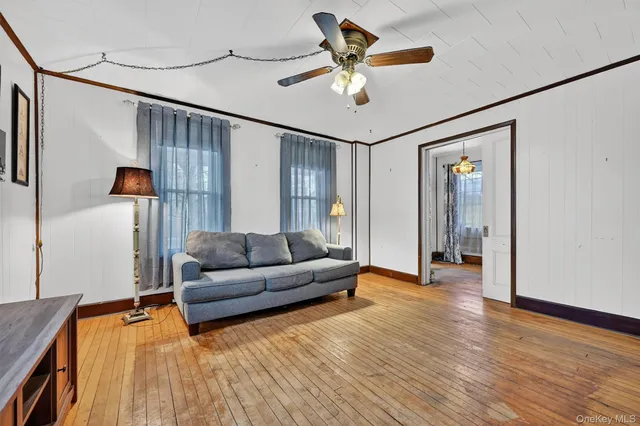 a living room with furniture and a wooden floor