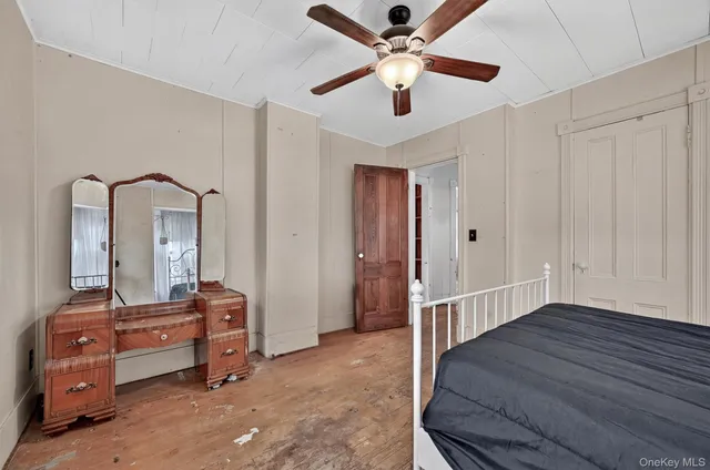 wooden floor in a room with a mirror and a dresser