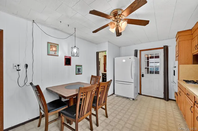 a view of a dining room with furniture and a chandelier