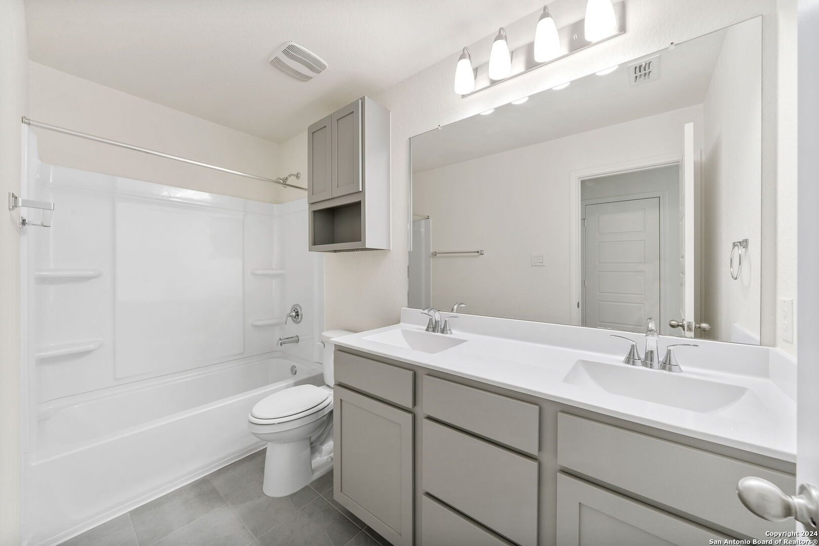 14839 Vance Jackson Road, Unit 910 San Antonio, TX 78249 - Photo 22 of 29 a bathroom with a sink a toilet and shower
