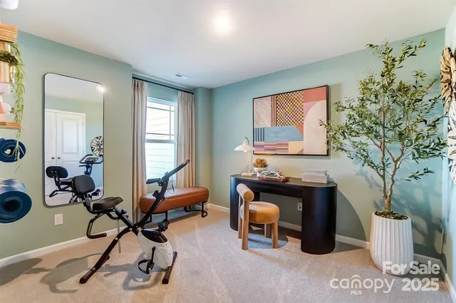 a view of a workspace with furniture and a window