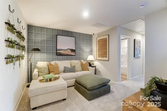 a living room with furniture and a potted plant